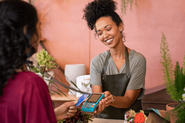 Customer using merchant services at small business.